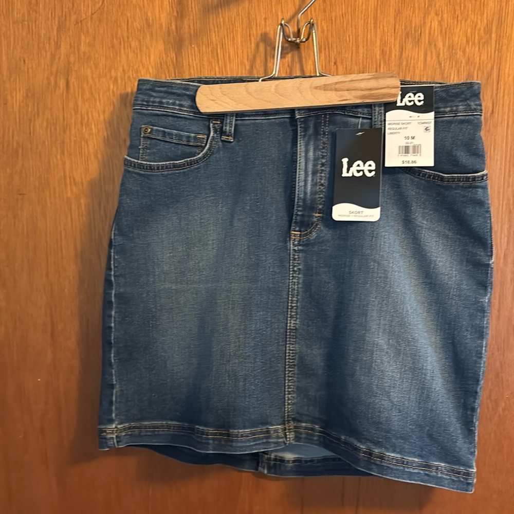 Brand new blue jeans skirt goes above the knees, front pockets, and back pockets